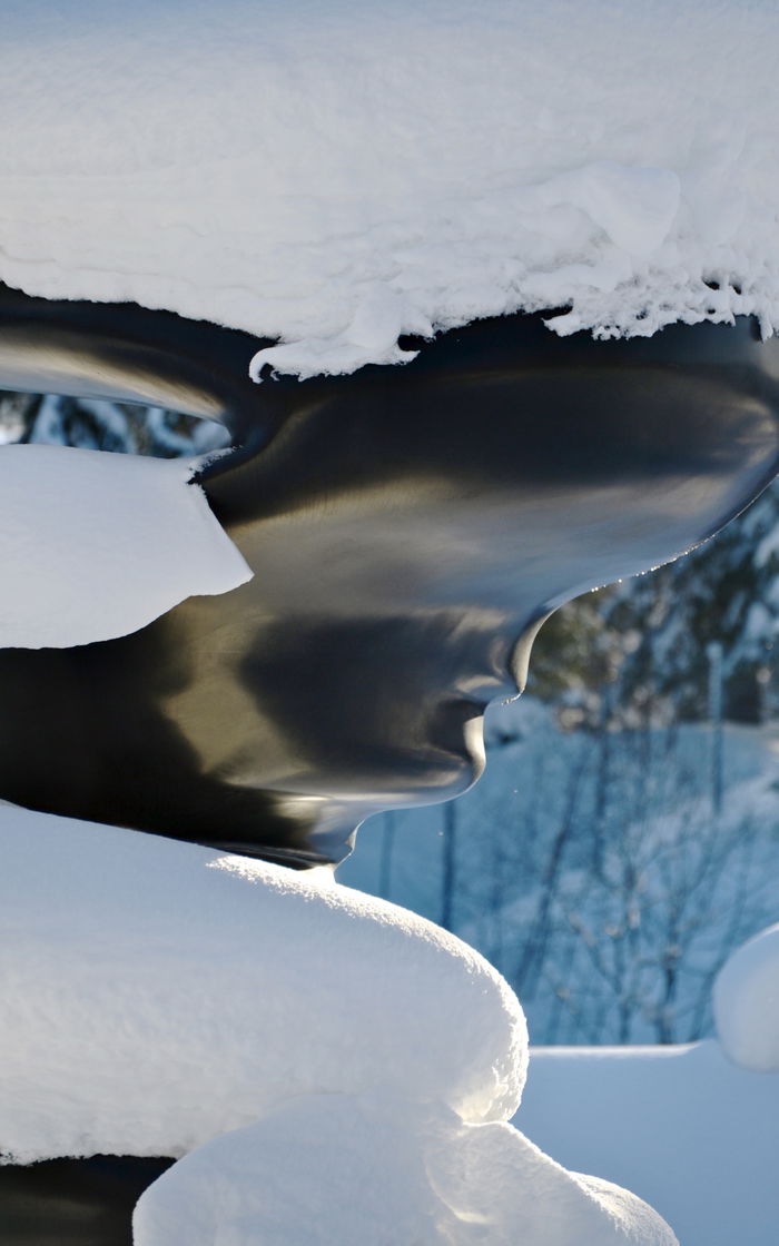 Detail of the sculpture Bent of Mind by Tony Cragg. Snow.